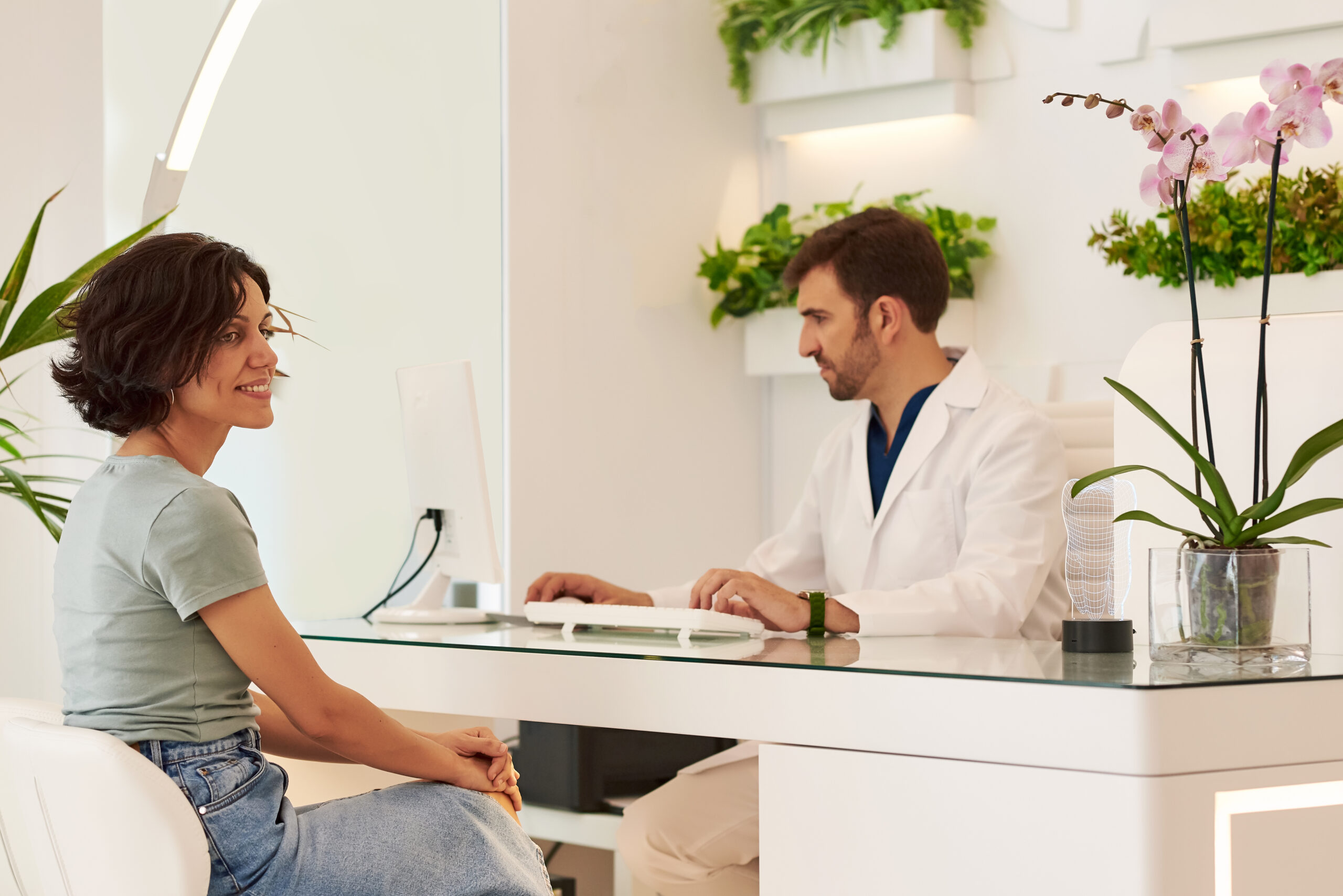 Doctor with a patient at the reception of the dental clinic.